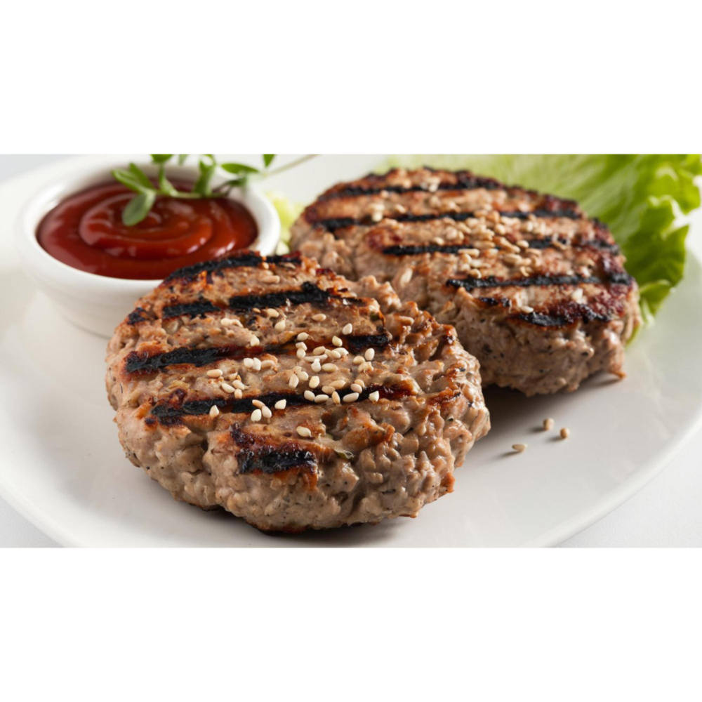 Zwei Burger auf einem Teller mit einer Schüssel Ketchup